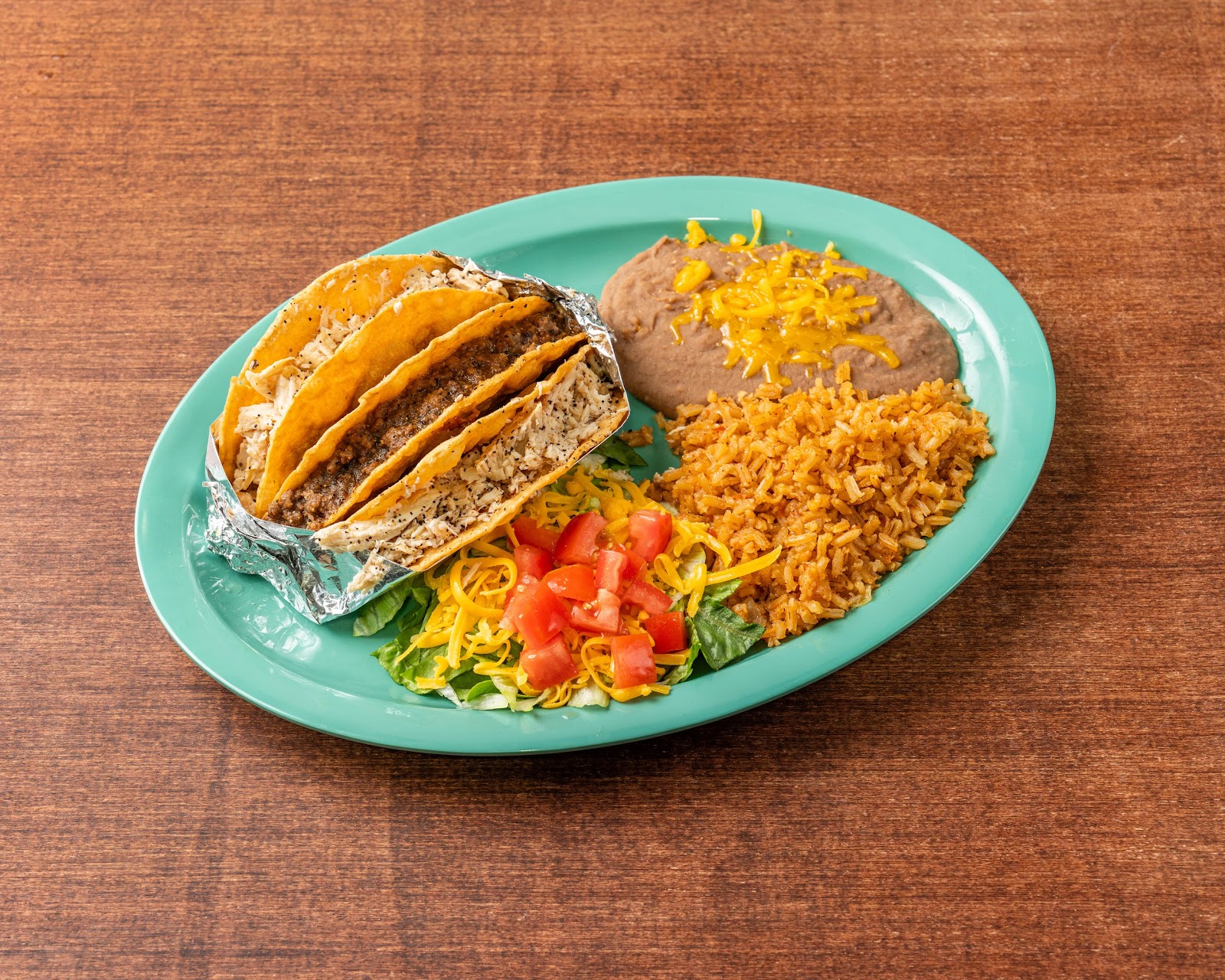 Shredded chicken mini tacos plate at Tomel's